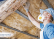 A person inspecting the roof of a home.
