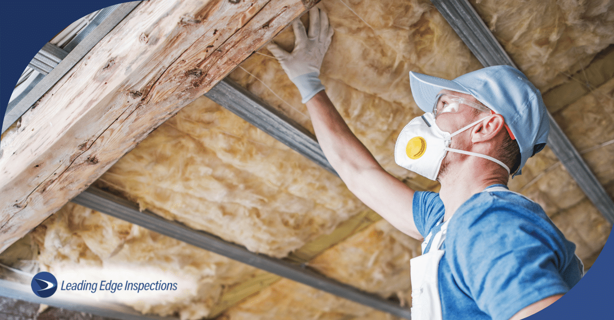A person inspecting the roof of a home.