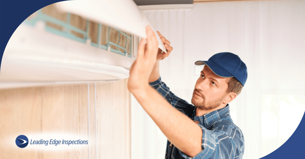 Inspector servicing wall-mounted air conditioning unit.